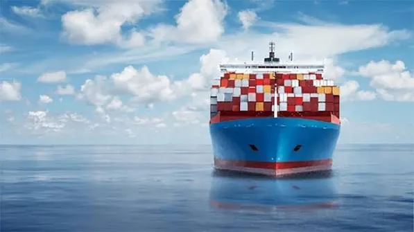 Container ship sailing on calm open sea